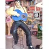 Giant statue of Elvis Presley sitting playing the King guitar